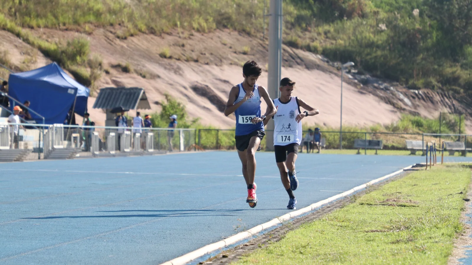 Atletas disputando uma prova em pista